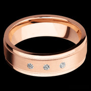 7 mm wide/Flat Stepped Edges Milgrain/14K Rose Gold band with an  arrangement of 3, .03 carat Round Diamond stones in a Flush setting.